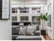 Living room featuring a gray sectional sofa, large windows with shutters, and modern decor at 653 N Highland Ne Ave # 3, Atlanta, GA 30306