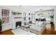 Bright living room features a modern fireplace, large windows, and a comfortable gray sectional sofa at 653 N Highland Ne Ave # 3, Atlanta, GA 30306