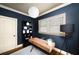 Office with a wooden desk, black shelves, and bright windows at 653 N Highland Ne Ave # 3, Atlanta, GA 30306
