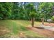 Spacious, lush backyard with mature trees, offering privacy and a serene outdoor space for relaxation and recreation at 221 The Esplanade Se Way, Loganville, GA 30052
