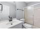 Bathroom featuring modern sink, toilet, and glass-enclosed shower at 221 The Esplanade Se Way, Loganville, GA 30052