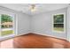 Bedroom with hardwood floors and ample natural light from the two large windows at 221 The Esplanade Se Way, Loganville, GA 30052