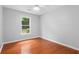 Clean bedroom with hardwood floors and a window providing natural light at 221 The Esplanade Se Way, Loganville, GA 30052