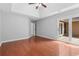 Bright bedroom with hardwood floors and access to the outdoors through glass doors at 221 The Esplanade Se Way, Loganville, GA 30052
