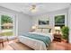 Bedroom with cozy decor, large windows, and hardwood floors at 221 The Esplanade Se Way, Loganville, GA 30052
