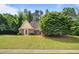 Charming single-story home with brick accents, a well-manicured lawn, and mature landscaping for added curb appeal at 221 The Esplanade Se Way, Loganville, GA 30052
