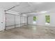 Spacious two-car garage with ample lighting and concrete floors at 221 The Esplanade Se Way, Loganville, GA 30052