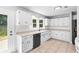 Bright kitchen with white cabinets, modern appliances, and access to the backyard at 221 The Esplanade Se Way, Loganville, GA 30052
