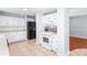 Kitchen features white cabinets, stainless steel appliances, and tile flooring at 221 The Esplanade Se Way, Loganville, GA 30052