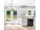 Bright kitchen with white cabinets, modern appliances, and a view of the backyard at 221 The Esplanade Se Way, Loganville, GA 30052