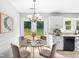 Bright eat-in kitchen with glass table and white cabinets, perfect for casual dining at 221 The Esplanade Se Way, Loganville, GA 30052