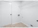Laundry room with tile floor and built-in shelving at 221 The Esplanade Se Way, Loganville, GA 30052
