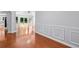 Bright open-concept living room with hardwood floors, wainscoting, and sliding doors to the backyard at 221 The Esplanade Se Way, Loganville, GA 30052