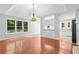 Living room with hardwood floors, large windows, and stylish lighting at 221 The Esplanade Se Way, Loganville, GA 30052