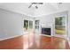 Light-filled living room with a fireplace and large windows overlooking the backyard at 221 The Esplanade Se Way, Loganville, GA 30052