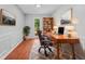 Office space with a large desk and chair and bookshelf with an abundance of natural light at 221 The Esplanade Se Way, Loganville, GA 30052