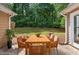 Outdoor patio featuring a wood table with comfortable chairs surrounded by green trees at 221 The Esplanade Se Way, Loganville, GA 30052