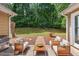 Outdoor patio featuring a BBQ and seating area surrounded by green trees at 221 The Esplanade Se Way, Loganville, GA 30052
