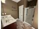 Neutral bathroom with a double sink vanity, framed mirror and glass door shower stall at 288 Blue Pointe Ct, Suwanee, GA 30024