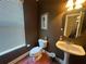 Charming powder room featuring a pedestal sink, window, and neutral decor at 288 Blue Pointe Ct, Suwanee, GA 30024