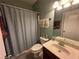 Cozy bathroom with a shower-tub combo, standard vanity and framed mirror at 288 Blue Pointe Ct, Suwanee, GA 30024