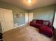 Bedroom featuring a red couch, natural light, and carpeted floors at 288 Blue Pointe Ct, Suwanee, GA 30024