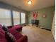 Bedroom featuring a red couch, natural light, and carpeted floors at 288 Blue Pointe Ct, Suwanee, GA 30024