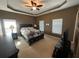 Main bedroom suite with tray ceilings, carpet floors, and natural light at 288 Blue Pointe Ct, Suwanee, GA 30024
