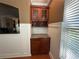Butler's pantry featuring granite counters, wood cabinets, wine rack, and convenient serving space at 288 Blue Pointe Ct, Suwanee, GA 30024