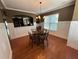 Formal dining room featuring hardwood floors, chandelier lighting, and views from multiple windows at 288 Blue Pointe Ct, Suwanee, GA 30024
