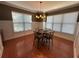 Sunlit dining room with hardwood floors, chandelier lighting, and multiple windows with views at 288 Blue Pointe Ct, Suwanee, GA 30024