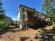 Back of townhome with wooden deck and screened porch overlooking lawn at 288 Blue Pointe Ct, Suwanee, GA 30024