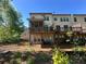 Back of townhome with wooden deck and screened porch overlooking lawn at 288 Blue Pointe Ct, Suwanee, GA 30024