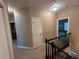 Upstairs hallway with neutral paint and carpet at 288 Blue Pointe Ct, Suwanee, GA 30024