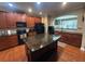 Spacious kitchen featuring stainless steel appliances, granite counters, central island and views to dining at 288 Blue Pointe Ct, Suwanee, GA 30024