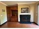 Living room boasts a fireplace, built-in cabinetry, and hardwood floors at 288 Blue Pointe Ct, Suwanee, GA 30024