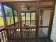 View of screened porch with chair, ceiling fan, and backyard view at 288 Blue Pointe Ct, Suwanee, GA 30024