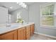 Bright bathroom with double sink vanity, large mirror, and a window at 4922 Carson Glen Ln, Acworth, GA 30101