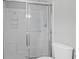 Bright bathroom featuring a glass shower door and white tiled walls at 4922 Carson Glen Ln, Acworth, GA 30101