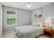 Cozy bedroom featuring a queen-sized bed, window, ceiling fan, and an end table with lamp at 4922 Carson Glen Ln, Acworth, GA 30101