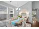 Bright dining room features hardwood floors, decorative lighting, and natural light from large windows at 4922 Carson Glen Ln, Acworth, GA 30101