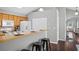 Open kitchen with breakfast bar, white appliances, and hardwood floors at 4922 Carson Glen Ln, Acworth, GA 30101