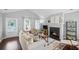 Bright living room featuring a fireplace, modern decor, comfortable seating, and hardwood floors at 4922 Carson Glen Ln, Acworth, GA 30101