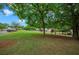 Large grassy yard with mature shade trees, landscaping, and charming residential neighborhood at 4922 Carson Glen Ln, Acworth, GA 30101