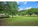 Expansive grassy yard with mature trees and a charming gazebo in the background at 4922 Carson Glen Ln, Acworth, GA 30101