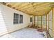 Covered back patio with stone tile flooring, lattice surround and wooden ceiling for a cozy outdoor relaxation space at 1010 Capella Creek Way, Grayson, GA 30017
