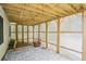Covered back porch featuring stone tile, lattice enclosure and wooden ceiling, creating a private outdoor space at 1010 Capella Creek Way, Grayson, GA 30017