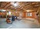 Large unfinished basement with exposed wood framing, concrete floor and natural light, ready for customization at 1010 Capella Creek Way, Grayson, GA 30017