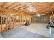 Unfinished basement featuring exposed ceiling with framing, carpet remnants, and ample space for various activities at 1010 Capella Creek Way, Grayson, GA 30017
