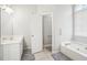 Bright bathroom with double sinks, lots of counterspace, bathtub, and a glass shower at 1010 Capella Creek Way, Grayson, GA 30017